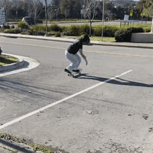 a person is riding a skateboard down a street in front of a sign that says " no parking "