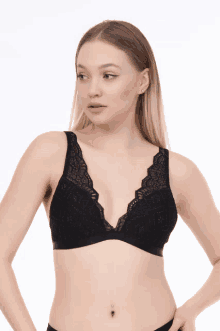 a woman is wearing a black lace bra