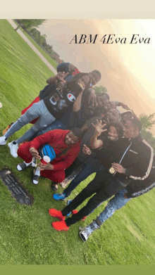 a group of people posing for a picture in front of a grave with abm 4eva evo on the bottom