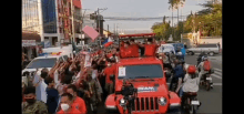 a jeep with the word team on the front is driving down a street