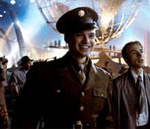 a man in a military uniform is smiling in front of a large globe