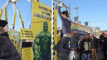 a man is doing a pull up in front of a hulk sign