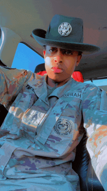 a man in a military uniform is wearing a cowboy hat and has the name josiah on his chest