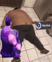 a man is laying on the floor with a sign that says revive on it .