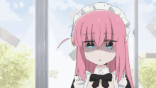 a girl with pink hair and a maid outfit is standing in front of a window with her eyes closed .