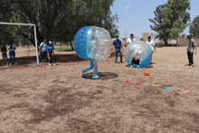 a group of people are playing a game of bubble football