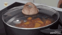 a pot of food with a glass lid on a stove .