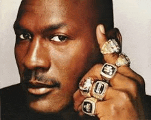 michael jordan is wearing a bunch of rings on his fingers .