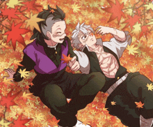 a couple of anime characters are laying on a pile of leaves