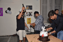 a group of men are cutting a cake with a sign that says " always remembers "