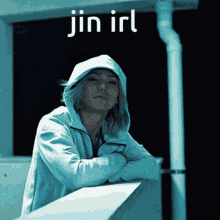 a person wearing a hooded jacket with the words jin irl above them