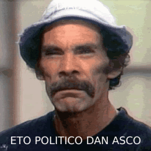 a man with a hat and a mustache has the words eto politico dan asco above him