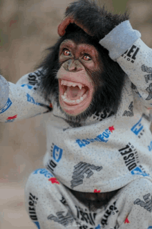 a chimpanzee wearing a sweatshirt with diesel on it