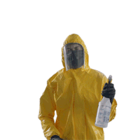 a person wearing a yellow protective suit is spraying something