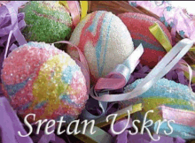 colorful easter eggs in a basket with the words sretan uskrs above them