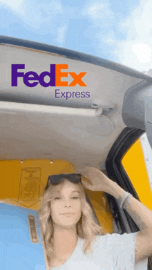 a fedex express ad with a woman holding a blue box