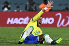 a soccer player with the number 10 on his shirt is laying on the ground