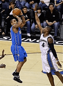 a basketball player with the number 4 on his jersey is jumping up to shoot the ball