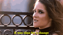 a woman stands in front of a wrought iron fence with the words " it was time for a change " below her