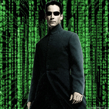 a man wearing sunglasses stands in front of a green matrix background