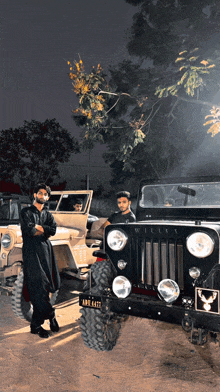 a man stands in front of a jeep with a license plate that says ' aa '