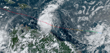 an aerial view of a tropical cyclone with a red line going through it