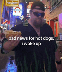 a man holding a hot dog with the words bad news for hot dogs i woke up on the bottom