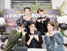 a group of young men are posing in front of a banner that says nov days