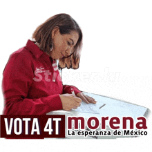 a woman in a red shirt is signing a form that says vota 4t morena on it