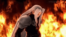 a man with long white hair is standing in front of a fire in a video game .