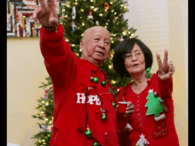 a man and a woman wearing red sweaters with the word hope on them