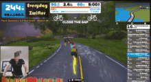 a screen shows a person riding a bike on a zwifter app