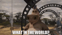 a cartoon rhinoceros is standing in front of a metal arch and asking what in the world .