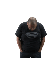 a bald man with a beard wears a black superman t-shirt