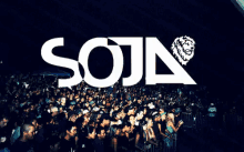 a crowd of people are gathered in front of a soja logo