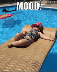 a baby in a bikini is laying on a raft in a pool with the words mood above her