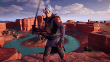 a man holding a sword in front of a river in a video game