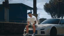 a man sits on the front of a white sports car in a video game scene