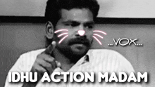 a black and white photo of a man with a cat face on his face and the words idu action madam .