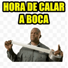 a man is holding a roll of duct tape with the words hora de calar a boca above him