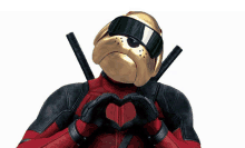 a man in a deadpool costume is making a heart with his hands