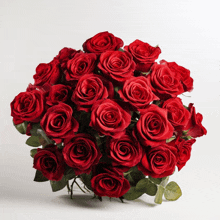 a bunch of red roses on a white surface