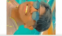 a man is wearing sunglasses and smiling in a pool .