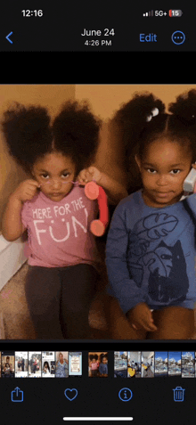 two little girls are sitting next to each other and one of them is wearing a pink shirt that says here for the fun