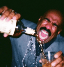 a man with a mustache is pouring a drink from a bottle