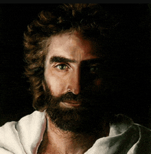 a close up of jesus ' face with a beard and curly hair