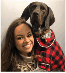 a woman and her dog are posing for a picture