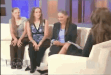 a group of women are sitting on a couch on a tv show that says tya