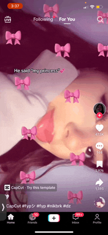 a girl with pink bows on her face is laying down on a bed