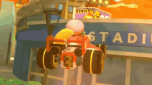 a cartoon character is riding a toy car in front of a building that says stadium